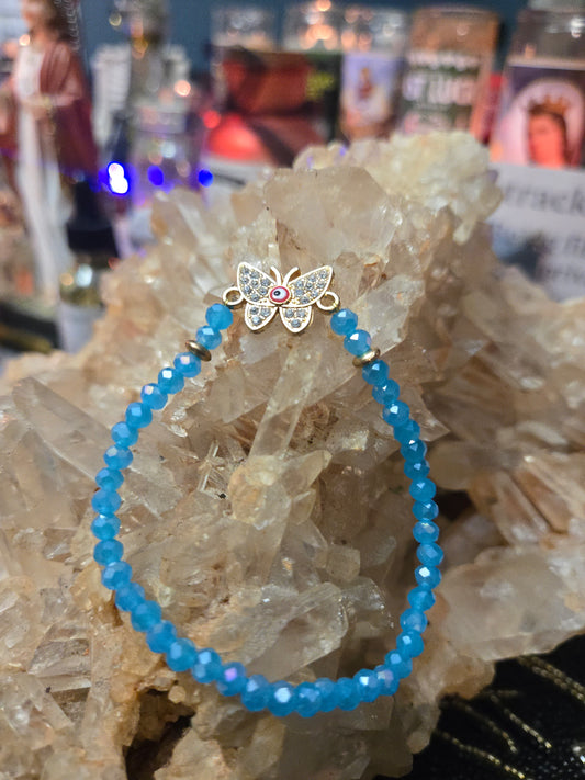 Blue Beaded Bracelet with Butterfly Charm & Red Evil Eye – Protection & Transformation